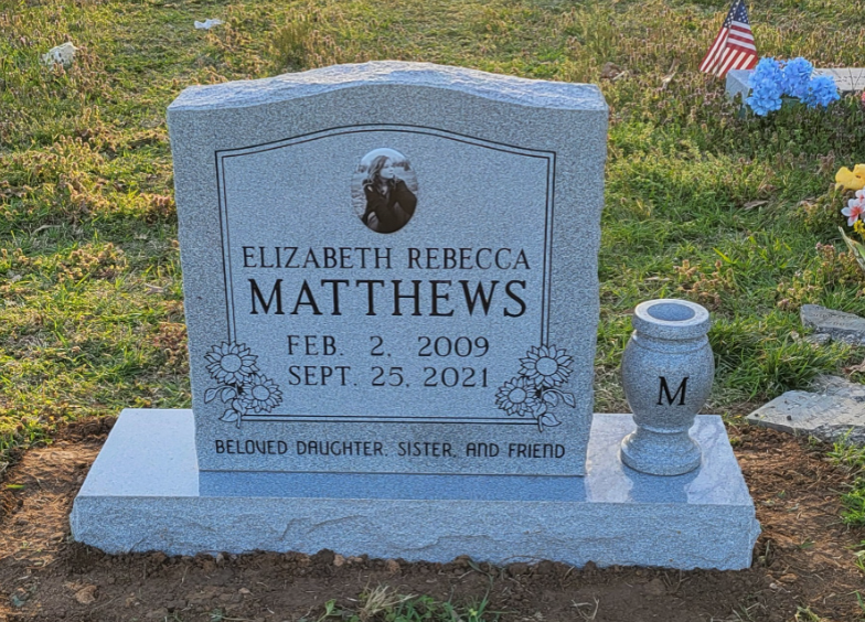 single upright monument with vase